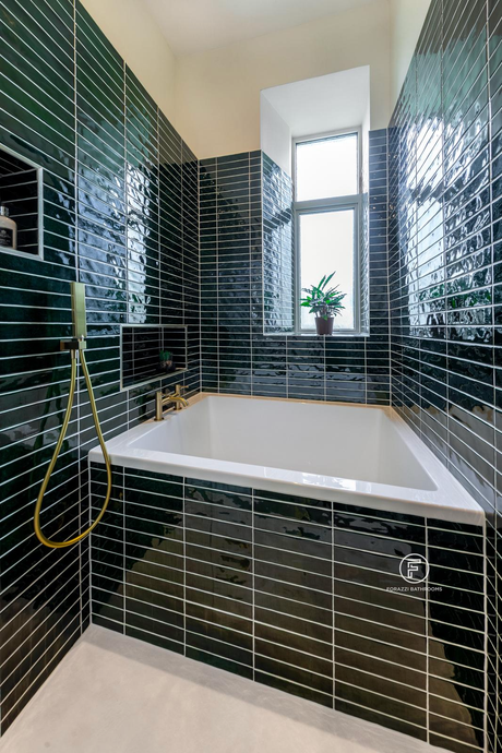 Compact Edinburgh tenement bathroom by Forazzi Bathrooms — 1300 × 950mm Omnitub Solo Sups deep soaking tub in glazed emerald tile alcove with brushed brass shower handheld and original tenement window — handmade in Britain