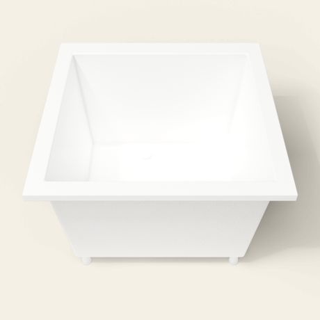 Omnitub 1050×1050 white deep soaking bath — end view, with feet [render:1_end_view:feet]