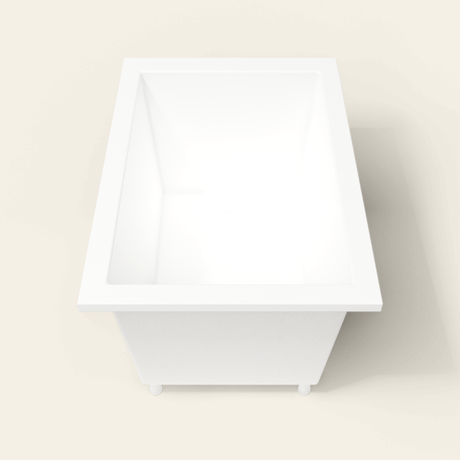 Omnitub 1250×850 white deep soaking bath — end view, with feet [render:1_end_view:feet]