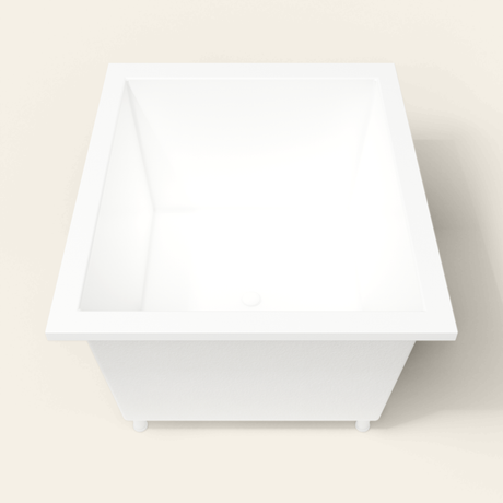 Omnitub 1250×1050 white deep soaking bath — end view, with feet [render:1_end_view:feet]