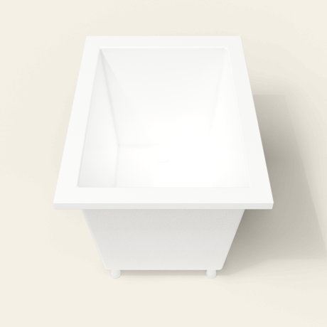Omnitub 1050×750 white deep soaking bath — end view, with feet [render:1_end_view:feet]