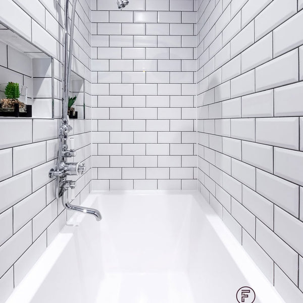 Side view of Omnitub Deluxe 1700 × 750mm white deep soaking tub showing 600mm internal soaking depth in a narrow Edinburgh tenement bathroom — handmade in Britain by Omnitub