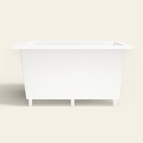 Omnitub 1300×950 white deep soaking bath — side profile, with feet [render:7_long_side:feet]