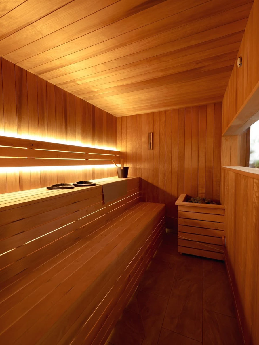 Backlit cedar benching inside the sauna