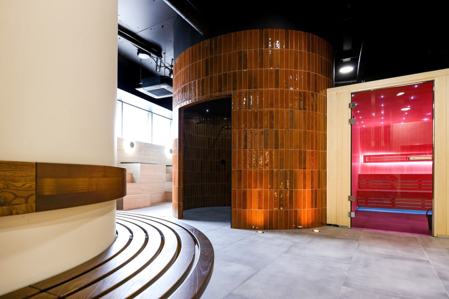 The orange glass-brick drum and terrazzo steps