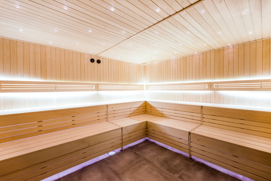 Blonde cedar sauna with a cool LED floor line