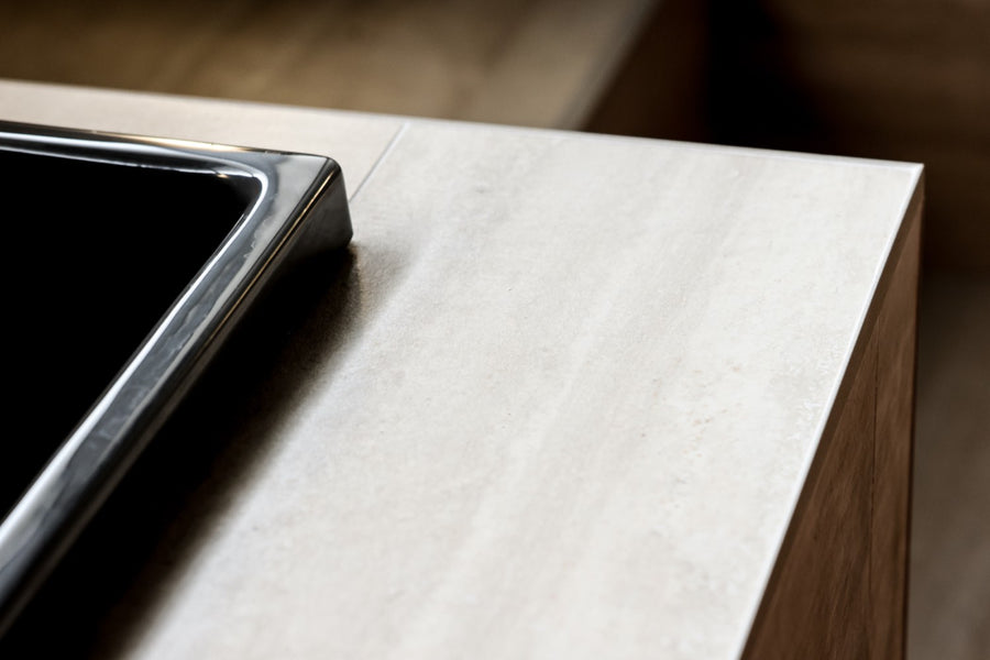 Black tub lip on honed stone — the Omnigel edge